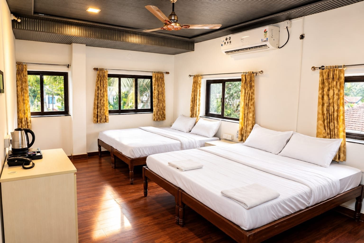 Family room with two double beds at Omnia By The Sea