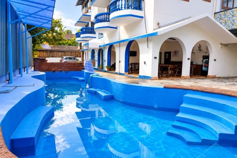 Swimming pool and resort building at Omnia By The Sea, Candolim, Goa