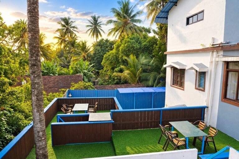 Sun terrace surrounded by palm trees at Omnia By The Sea